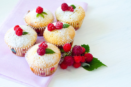 muffins with berries raspberries on a napkinの写真素材