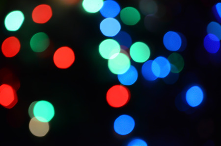 Bright abstract circular bokeh background blur on a dark backgroundの写真素材