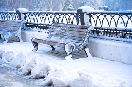 Winter snow, bench in the snow at the park