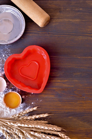 wooden background of spilled egg flour with yolk stalks of wheat and baking dish
dough roll, selective focusの写真素材
