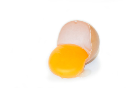 eggs on a white background broken with the yellow yolk of selective focus