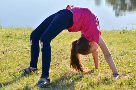 the girl makes a bridge to nature selective focusの写真素材