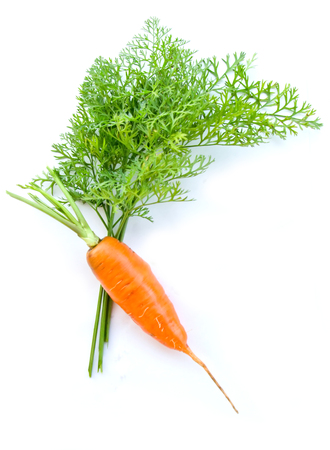 carrot and carrot leaves on white background selective focusの写真素材