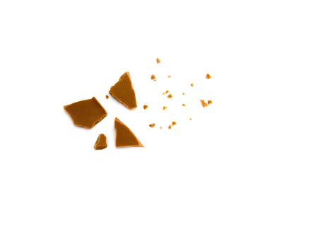 pieces of milk chocolate and crumbs on white background selective focusの写真素材
