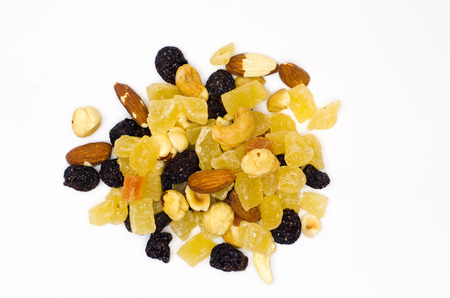 mixture of nuts and candied fruits and raisins on white backgroundの写真素材
