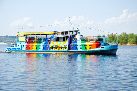 a small brightly painted ship sailing on the river selective focusの写真素材