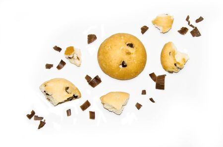 chocolate cookies and pieces of cookies and chocolate on a white background selectiveの写真素材