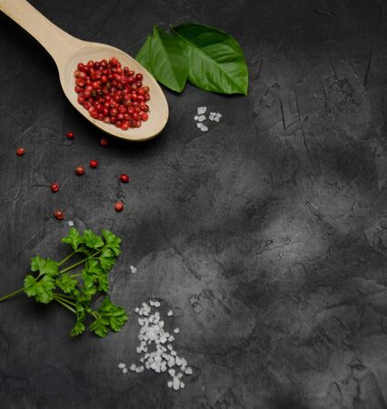 background for recording recipes large salt spices red pepper the leaves of parsley on a black background blurredの写真素材