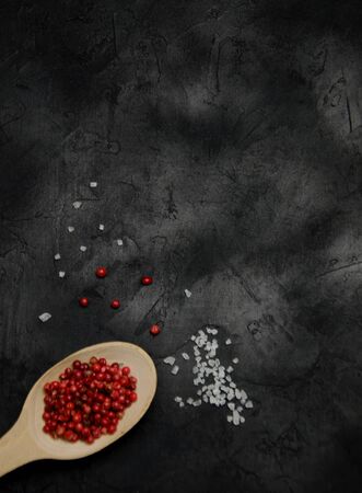 background for recording recipes large salt and a spoon of spices red pepper on a black background blurredの写真素材