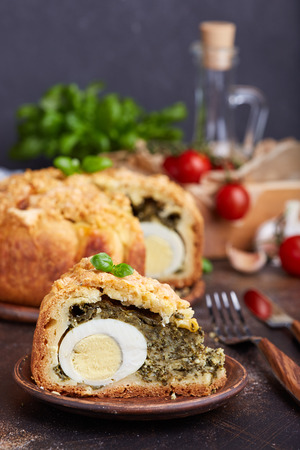 Delicious closed savory pie with eggs and spinach fillingの写真素材