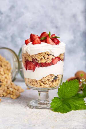 Healthy dessert with granola, yogurt and strawberrieの写真素材