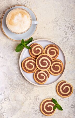 Two colored delicious homemade cookies with vanilla and chocolate flavor in a shape of spiralの写真素材