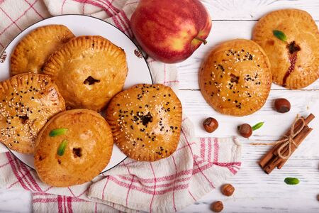 Delicious small sweet pies filled with apples, cinnamon and hazelnutsの写真素材