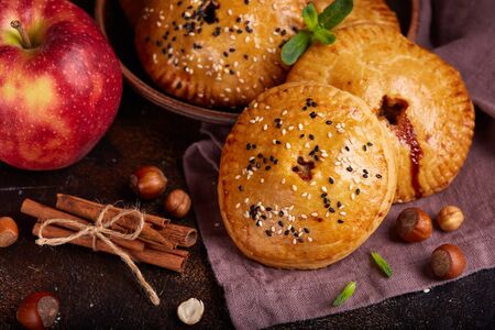 Delicious small sweet pies filled with apples, cinnamon and hazelnutsの写真素材