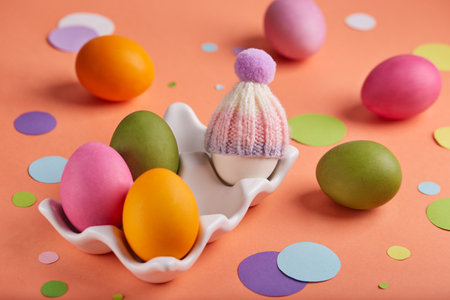 Colored Easter eggs decorated with hats. Spring greeting card banner with traditional Easter symbols.の写真素材