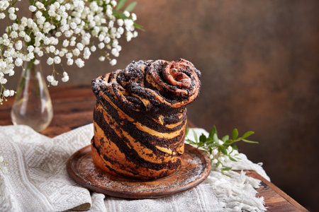 Yeast dough Cruffin bun with poppy seed and succades filling. Rolled up brioche, Easter baking.