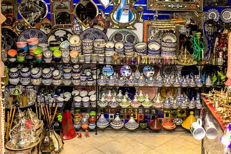 CHEFCHAOUEN, MOROCCO - APRIL 24, 2019: Colorful Moroccan fabrics and handmade souvenirs on the street in the blue city Chefchaouen, Morocco, Africa.の写真素材