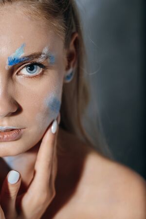 Creative fashion beauty portrait of beautiful young blonde woman with hairstyle. Model girl with...