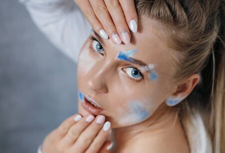 Creative fashion beauty portrait of beautiful young blonde woman with hairstyle. Model girl with...