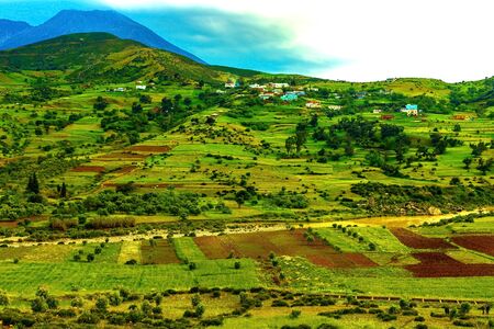 Beautiful mountain landscape. View of the mountains and the valley with land, sky and clouds,...