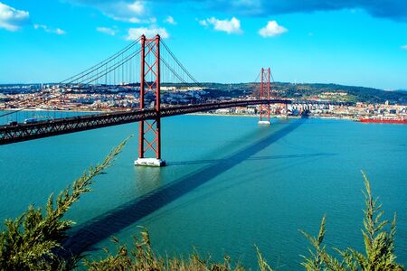 25th of April Bridge over the Tagus river, connecting Almada and Lisbon in Portugal.の写真素材