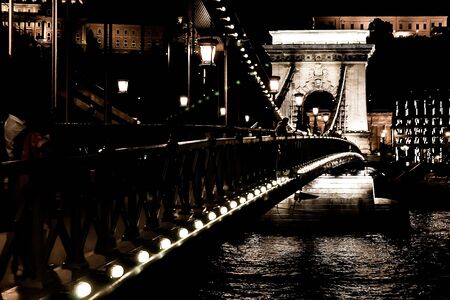 Amazing night view of the illuminated Chain Bridge close-up. Beautiful vintage lantern. Budapest, Hungary.の写真素材