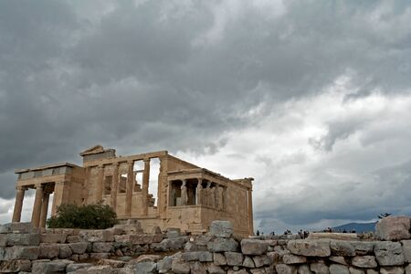 Temple Erechtheion with the famous porch of the caryatids instead of columns, against the background of the cloudy sky in the Acropolis. Athens, Greeceの写真素材