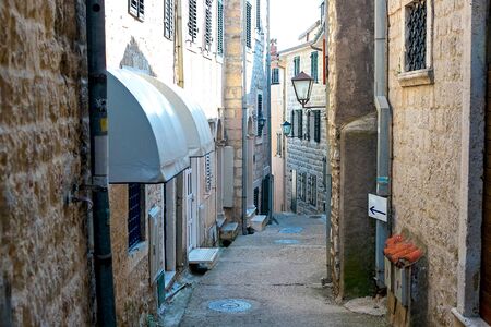 Winding street of the authentic, old town of Herceg Novi, Montenegro. We see old houses and very narrow.の写真素材