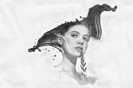 Reflection of a beautiful brunette girl in a water splash on a beige background.