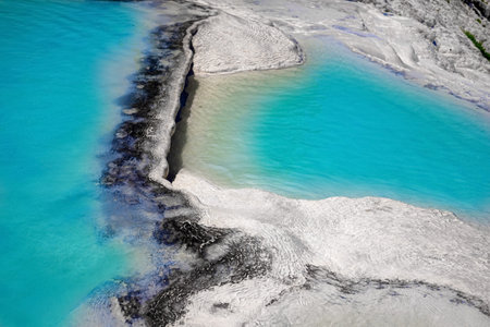 View of natural terraces in Pamukkale on a summer day. Close-up texture of limestone and water...