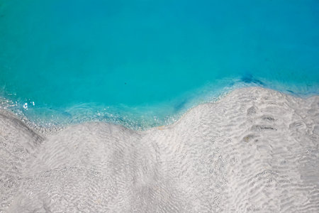 View of natural terraces in Pamukkale on a summer day. Close-up texture of limestone and water flowing over it.の写真素材