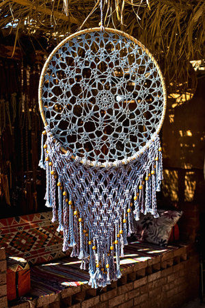 Dreamcatcher in front of a cafe under a thatched roofの写真素材