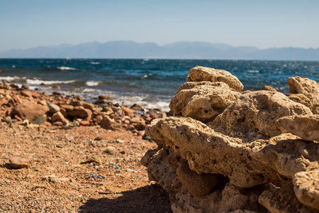 View of the Red Sea shore, pebble beach and kami close-up. Leisure concentration. Egypt, Dahabの写真素材