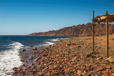 View of the Red Sea shore, pebble beach and kami close-up. Leisure concentration. Egypt, Dahabの写真素材