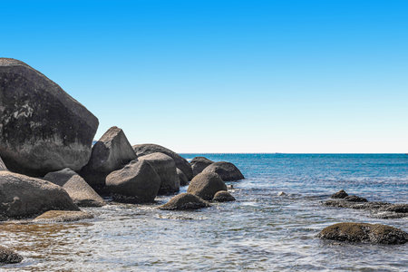 Huge rocks on the shore of the South China Sea in the Worlds End park. Sanya, Chinaの写真素材