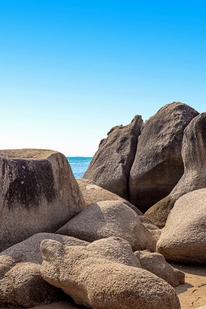 Huge rocks on the shore of the South China Sea in the Worlds End park. Sanya, Chinaの写真素材