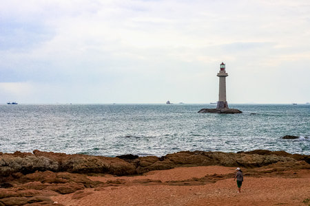 View of the lighthouse in the sea near the rocky shore. Heavenly Grottoes Park, Sanya, Chinaの写真素材