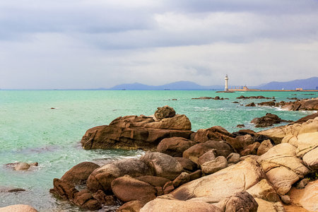 View of the lighthouse in the sea near the rocky shore. Heavenly Grottoes Park, Sanya, Chinaの写真素材