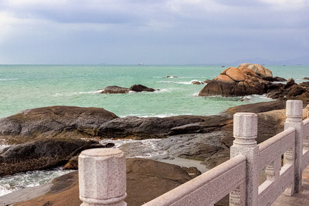 View of large rocks along the shore of the South China Sea. Sky Grottoes Park, Sanya, Chinaの写真素材