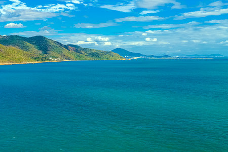 A picturesque view of the beach and mountain at Nianshan Park, Sanya, China.の写真素材