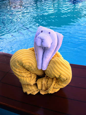 Towel Art - Folded towel animal around the swimming pool in the morning before shore excursion on board of cruise ship Caribbean Breezeの写真素材