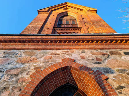 Old stone Church of St. Lawrence in daylight on a frozen January dayの写真素材