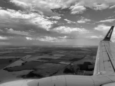 View from the window of a passenger plane. Black and white photo.