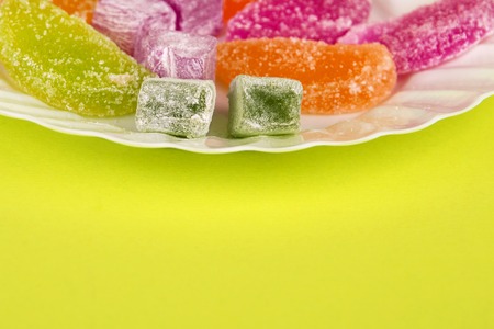 Marmalade and delight on a yellow background. Turkish sweets Multi-colored marmalade. Sweet fruit lemon marmalade. Jelly candies. Eastern sweets. Turkish delicaciesの写真素材