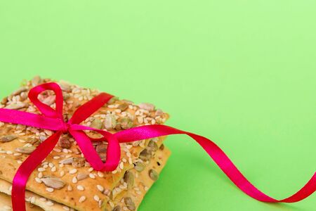 Homemade cookies on a green background. diet cookies with tape. Crisp bread with sunflower, flax and...