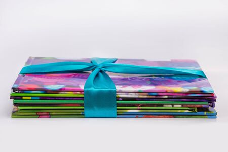 Colored books in a stack. Children's books in a gift ribbon. Bright colorful little books for...