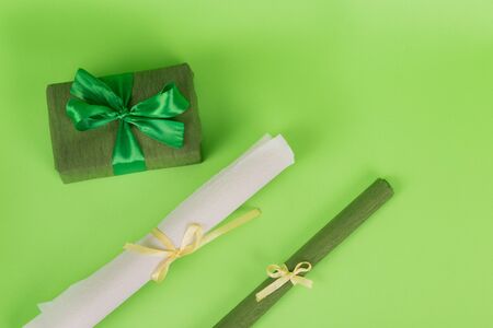 wrapped gift wrapping paper. green paper in a roll. Gift in green packaging. White paper in a rollの写真素材