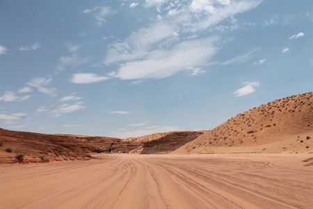 The wide view of desert with cars and blue skyの写真素材
