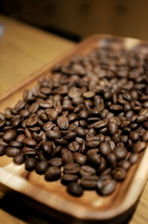 Coffee bean in the wood tray on the wood tableの素材