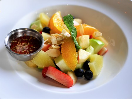Mix fruit salad with special sauce on the white plateの写真素材